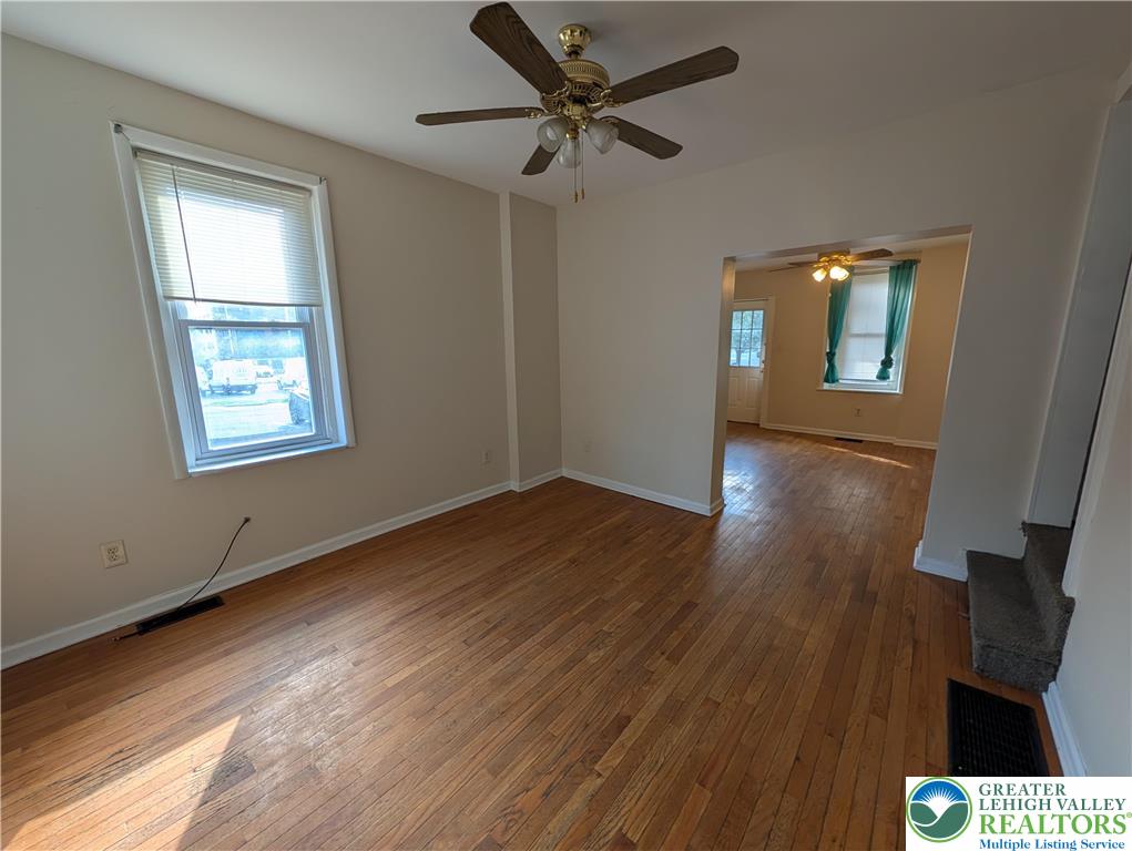 723 Chestnut Street Allentown, PA 18102 - Photo 5 of 25 a view of an empty room with wooden floor and a window