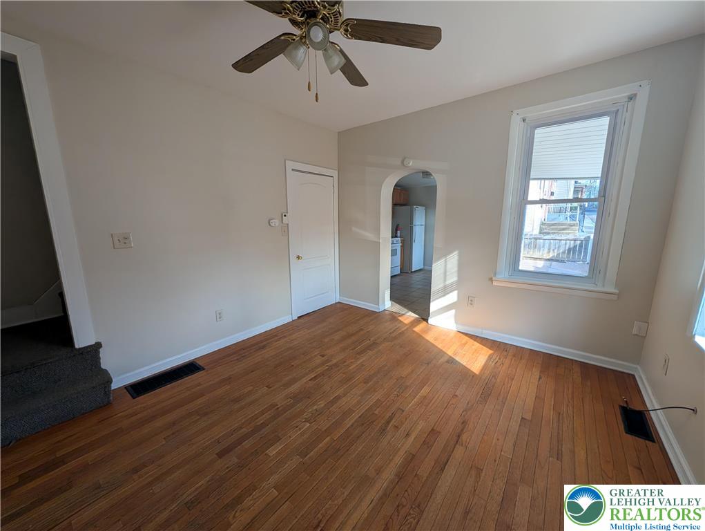 723 Chestnut Street Allentown, PA 18102 - Photo 6 of 25 a view of an empty room with wooden floor and a window