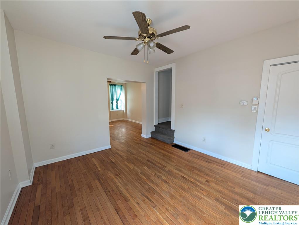 723 Chestnut Street Allentown, PA 18102 - Photo 8 of 25 a view of an empty room with wooden floor and a ceiling fan