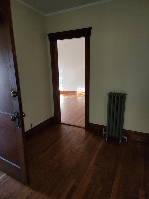 57 Austin Street, Unit 2 Boston, MA 02136 - Photo 4 of 17 an empty room with wooden floor and windows