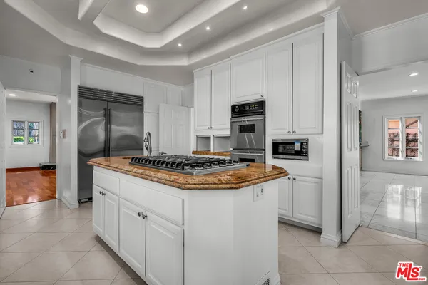 a kitchen with kitchen island cabinets and stove