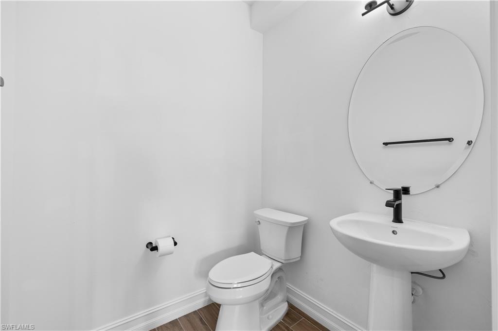 7548 Carnegie Way Naples, FL 34119 - Photo 6 of 20 Powder room on 1st level