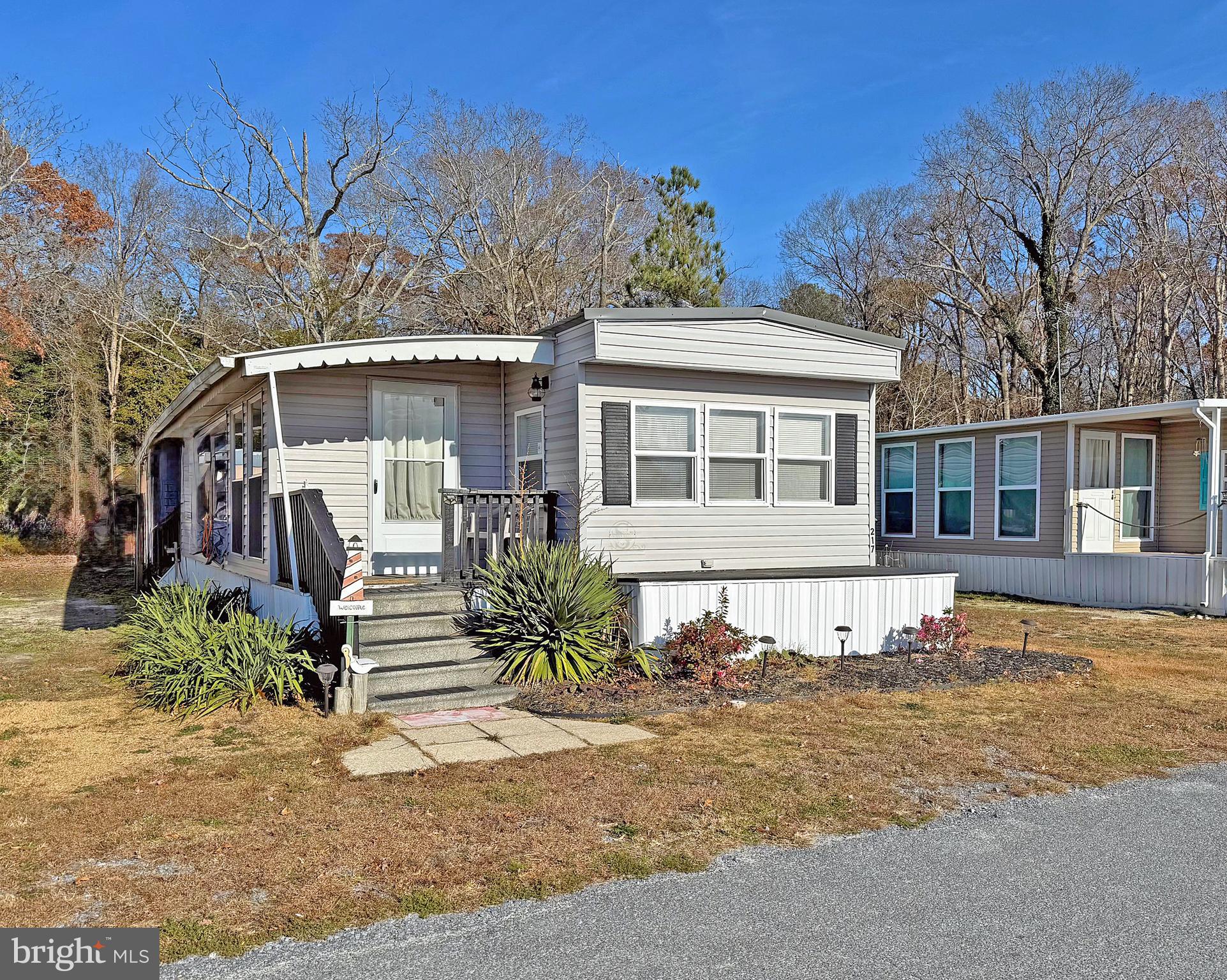 38306 Squirrel Road, Unit 217 Ocean View, DE 19970 - Photo 1 of 28 front view of a house with a yard