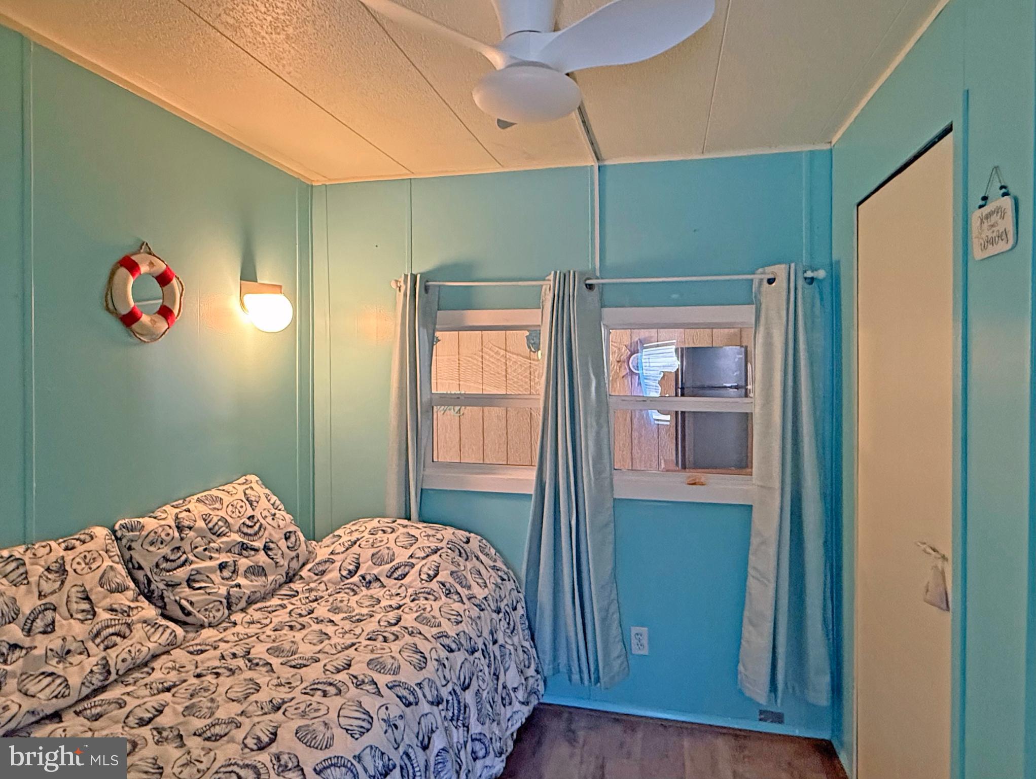 38306 Squirrel Road, Unit 217 Ocean View, DE 19970 - Photo 12 of 28 a bedroom with a bed and a window