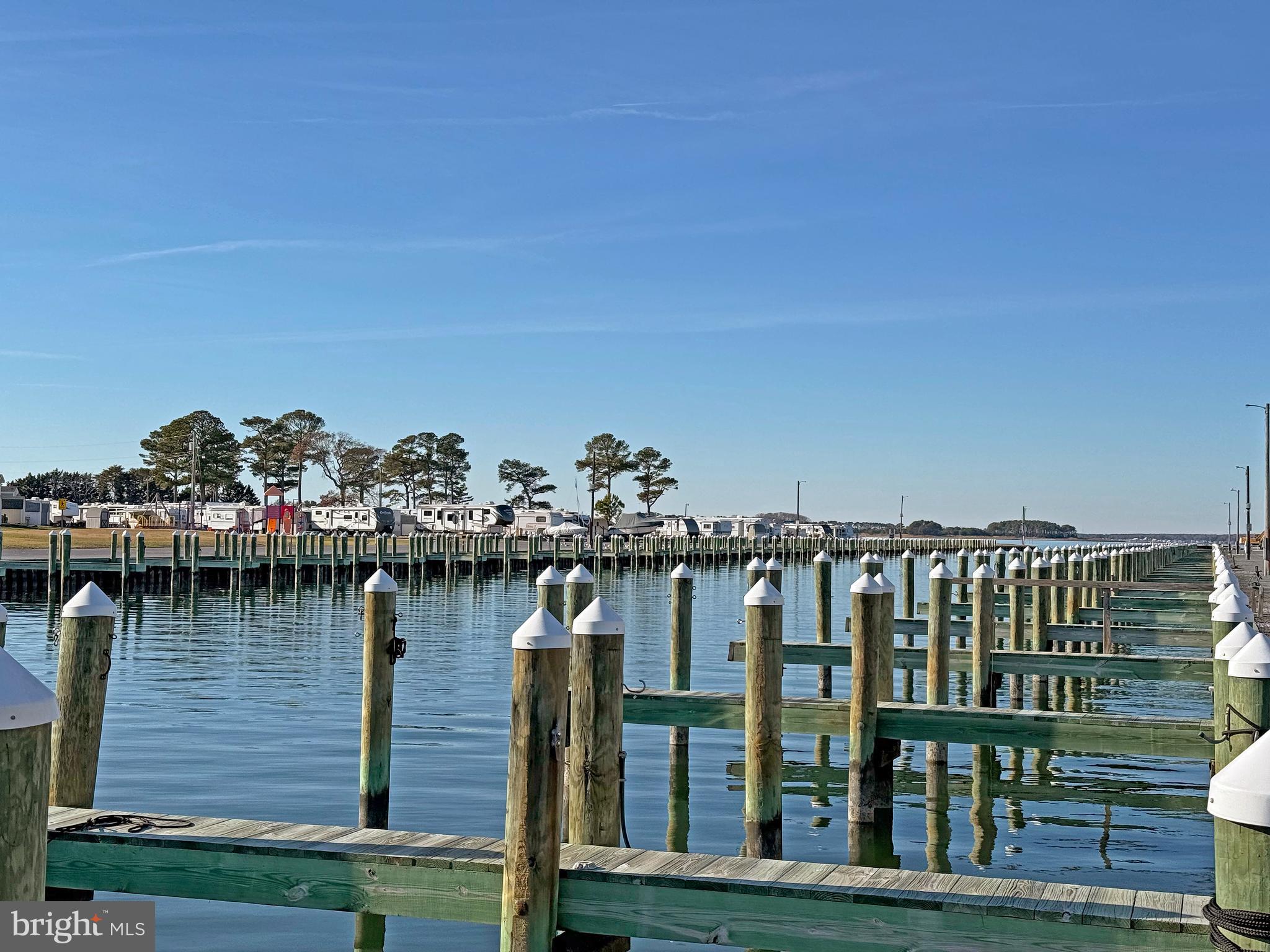 38306 Squirrel Road, Unit 217 Ocean View, DE 19970 - Photo 23 of 28 a view of a balcony with wooden chairs