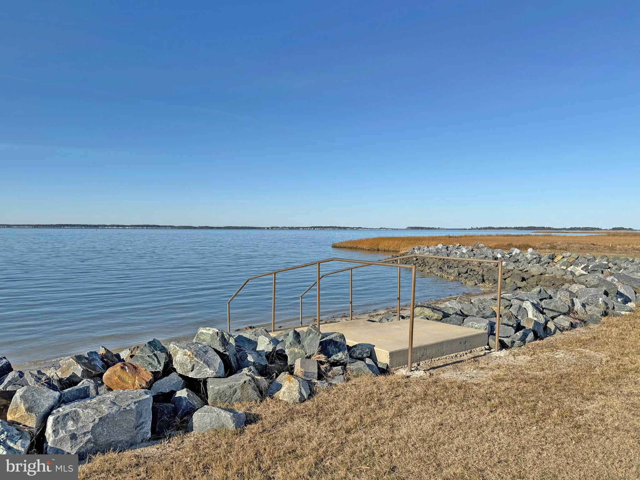 38306 Squirrel Road, Unit 217 Ocean View, DE 19970 - Photo 26 of 28 a view of a terrace with a bench