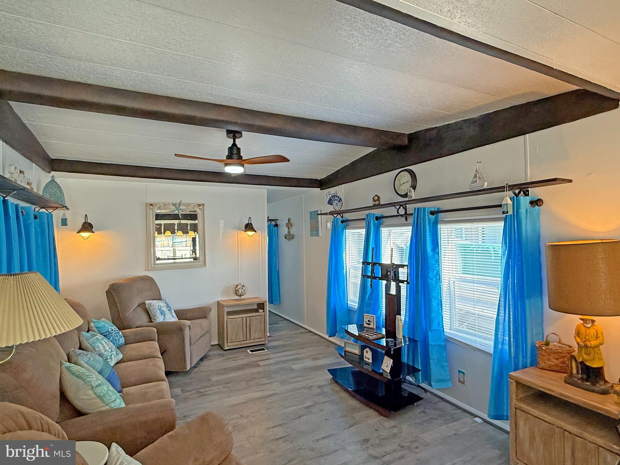 38306 Squirrel Road, Unit 217 Ocean View, DE 19970 - Photo 3 of 28 a living room with furniture and wooden floor