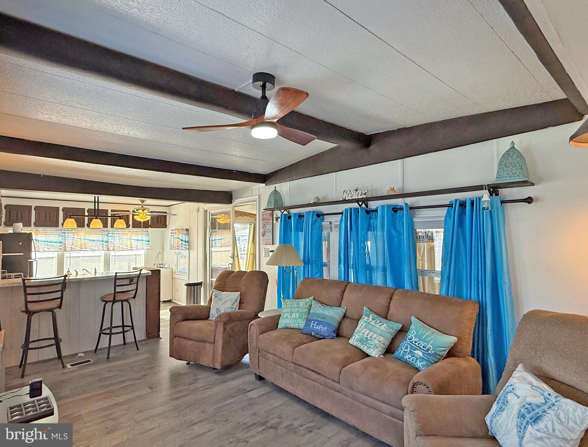 38306 Squirrel Road, Unit 217 Ocean View, DE 19970 - Photo 4 of 28 a living room with furniture and a large window