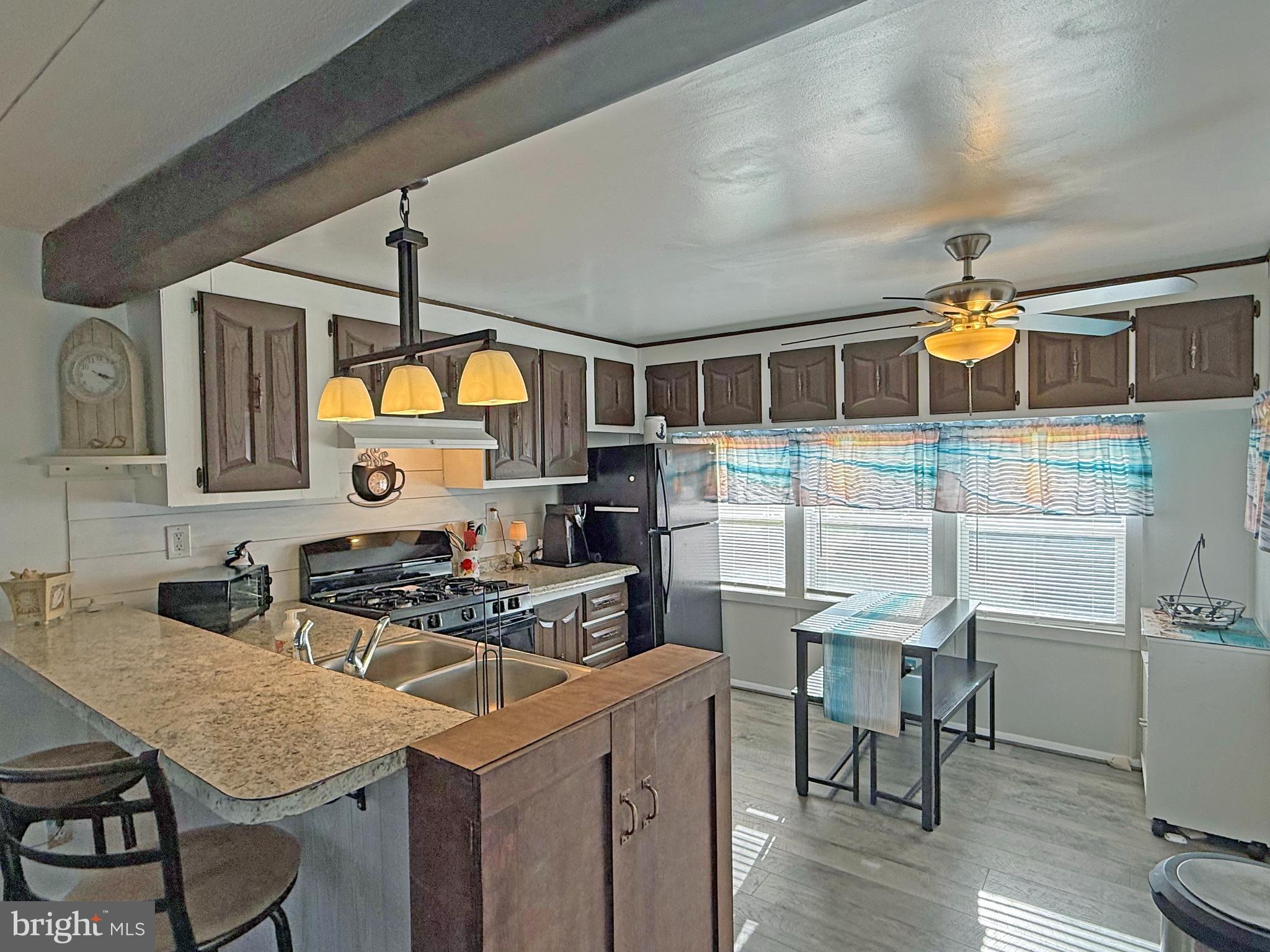 38306 Squirrel Road, Unit 217 Ocean View, DE 19970 - Photo 5 of 28 a kitchen that has a table and chairs in it