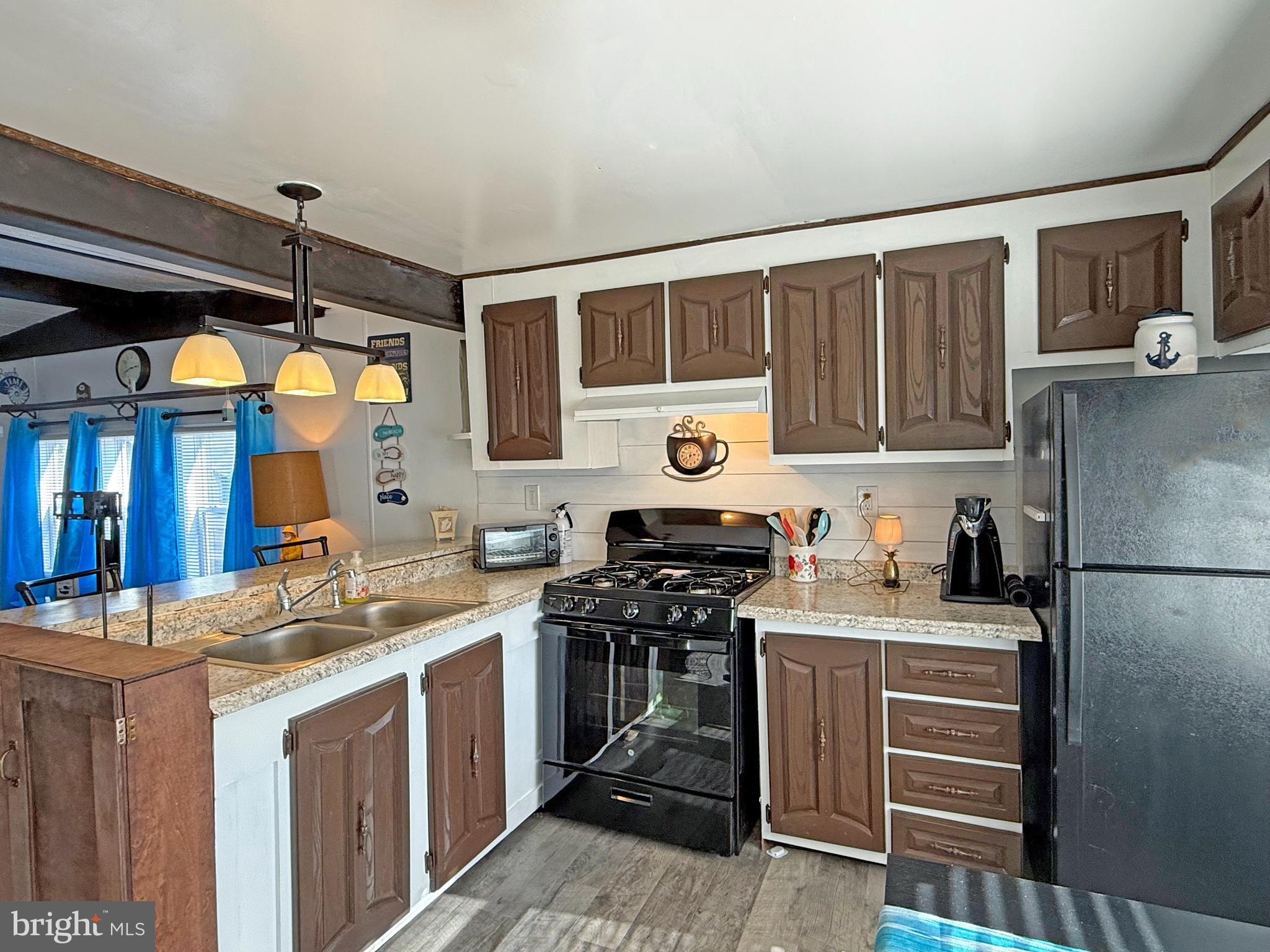 38306 Squirrel Road, Unit 217 Ocean View, DE 19970 - Photo 6 of 28 a kitchen that has a cabinets and a stove top oven