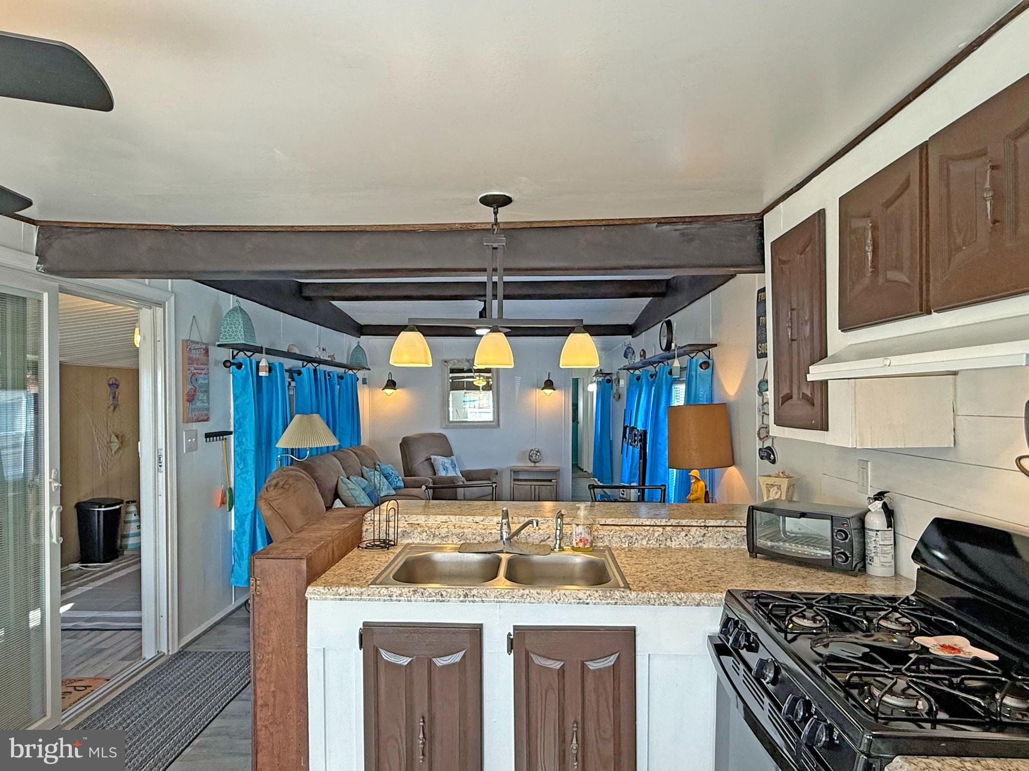 38306 Squirrel Road, Unit 217 Ocean View, DE 19970 - Photo 7 of 28 a kitchen with a stove and a refrigerator