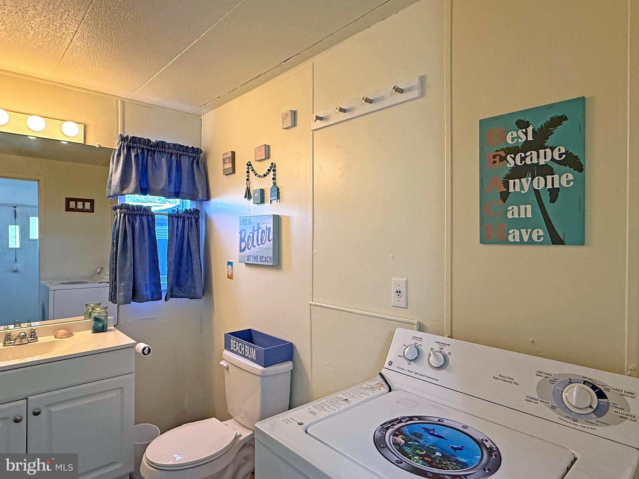38306 Squirrel Road, Unit 217 Ocean View, DE 19970 - Photo 10 of 28 a bathroom with a sink a toilet and shower curtain