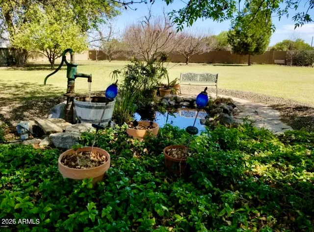 a view of a water pond with sitting area