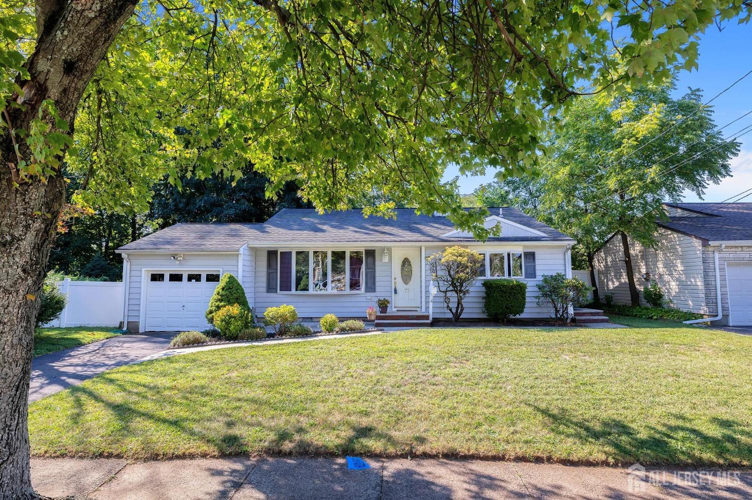 77 Albemarle Road Colonia, NJ 07067 - Photo 1 of 30 a front view of a house with garden