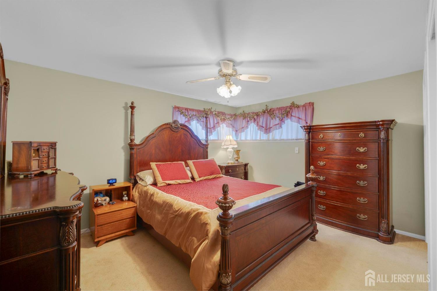 77 Albemarle Road Colonia, NJ 07067 - Photo 16 of 30 a bedroom with a bed and a chandelier