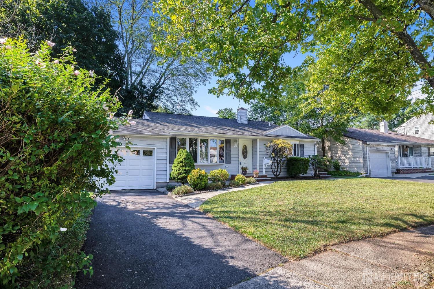 77 Albemarle Road Colonia, NJ 07067 - Photo 2 of 30 a front view of a house with a garden and porch