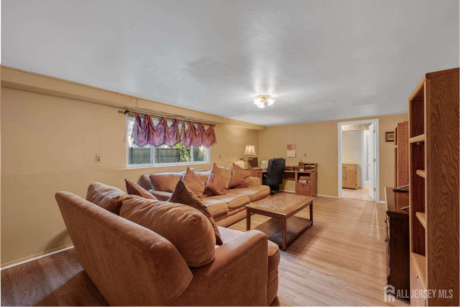 77 Albemarle Road Colonia, NJ 07067 - Photo 23 of 30 a living room with furniture window and a wooden floor