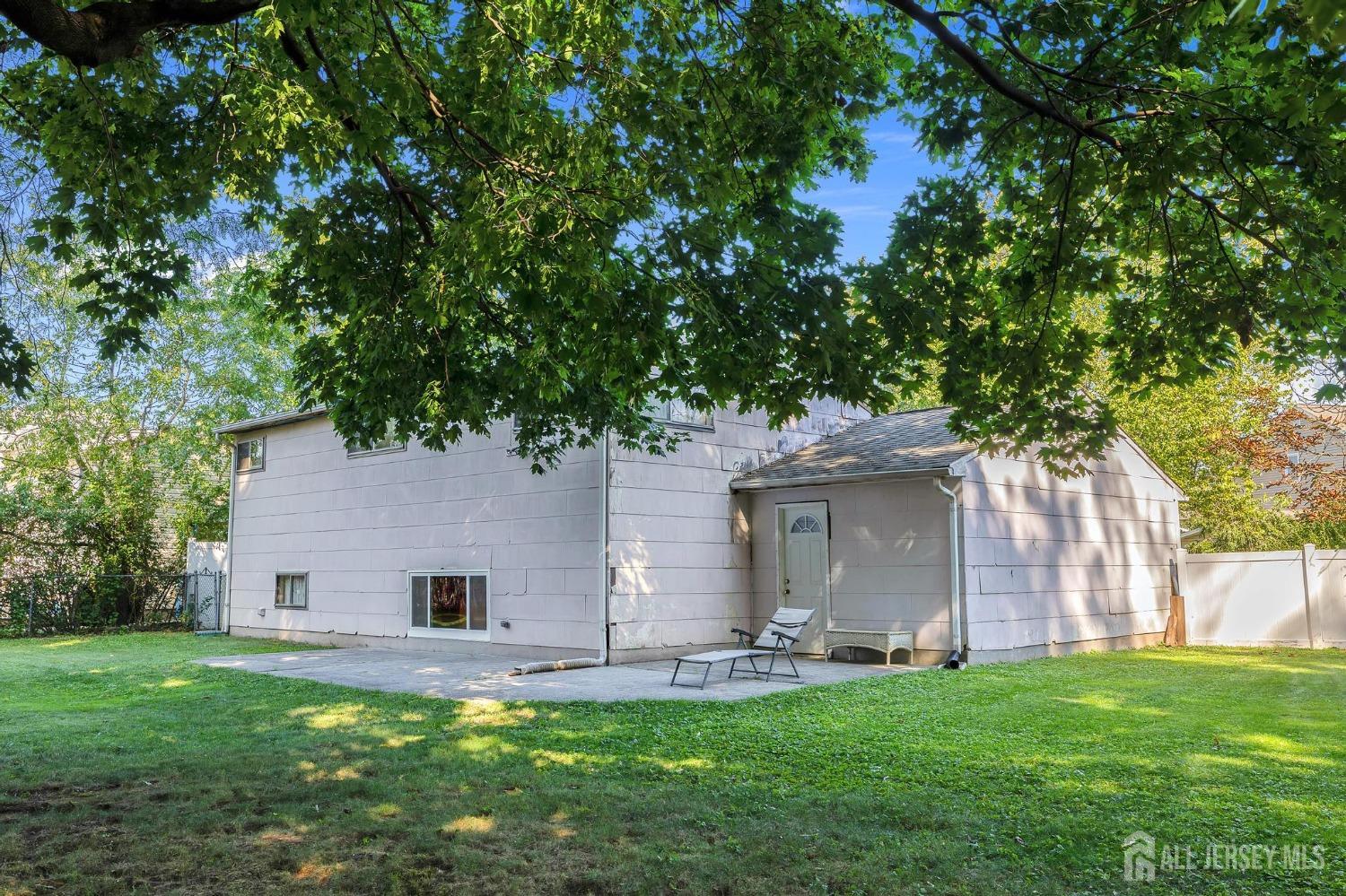 77 Albemarle Road Colonia, NJ 07067 - Photo 4 of 30 a front view of a house with a garden and yard