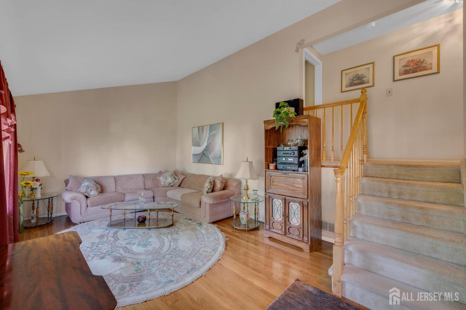 77 Albemarle Road Colonia, NJ 07067 - Photo 8 of 30 a living room with furniture and wooden floor