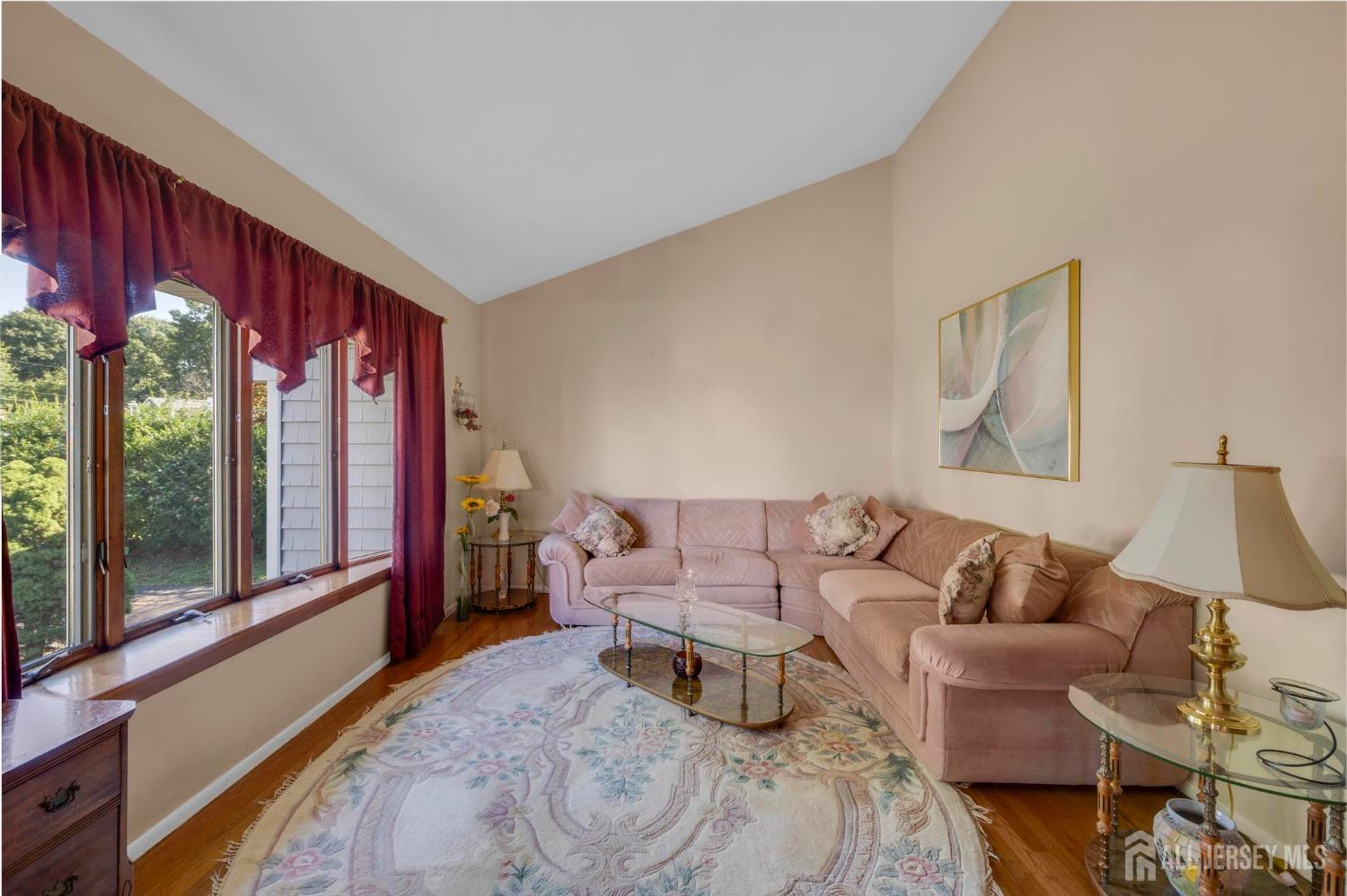 77 Albemarle Road Colonia, NJ 07067 - Photo 9 of 30 a living room with furniture and a large window