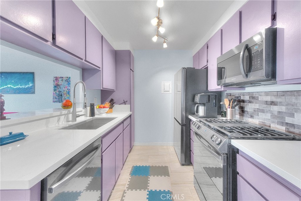 6351 Riverside Drive, Unit 69 Chino, CA 91710 - Photo 6 of 21 a kitchen with stainless steel appliances granite countertop a sink a stove and a refrigerator