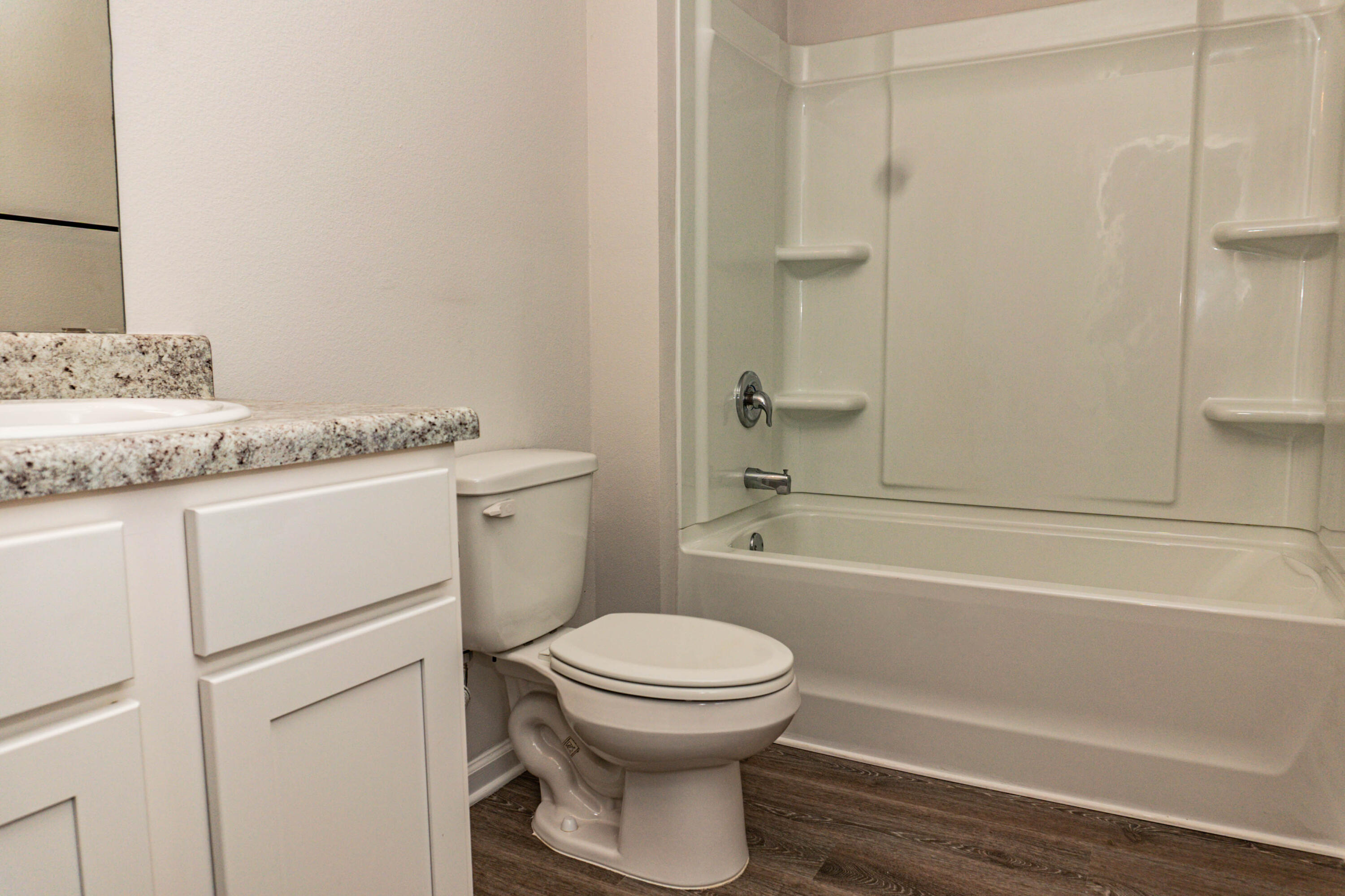 202 Laurel Hill Street Crestview, FL 32539 - Photo 15 of 25 a bathroom with a granite countertop toilet a sink and a bathtub