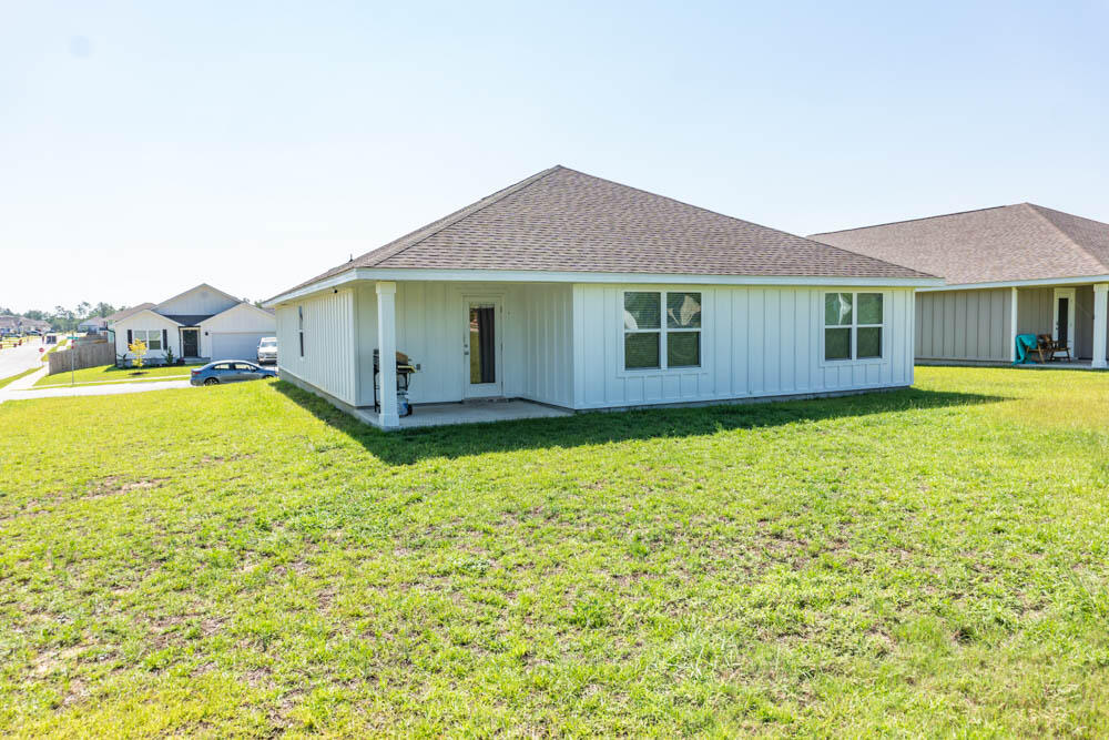 202 Laurel Hill Street Crestview, FL 32539 - Photo 17 of 25 a view of a house with pool and garden