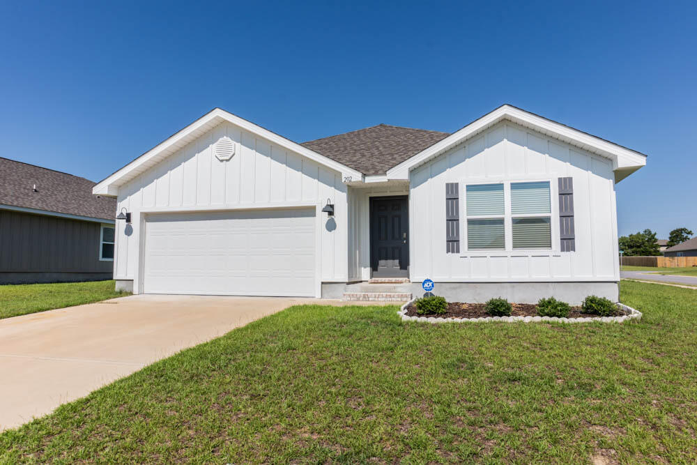 202 Laurel Hill Street Crestview, FL 32539 - Photo 18 of 25 a front view of a house with a yard