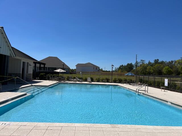 202 Laurel Hill Street Crestview, FL 32539 - Photo 22 of 25 a view of swimming pool with seating area and lake view