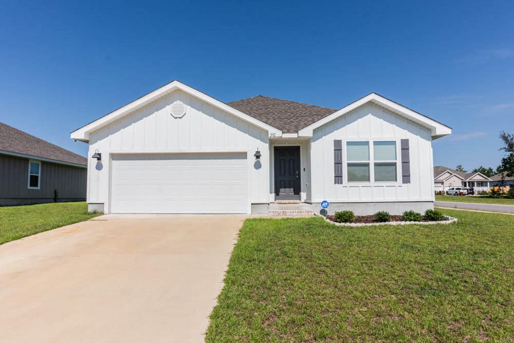 202 Laurel Hill Street Crestview, FL 32539 - Photo 24 of 25 a front view of a house with a yard and garage