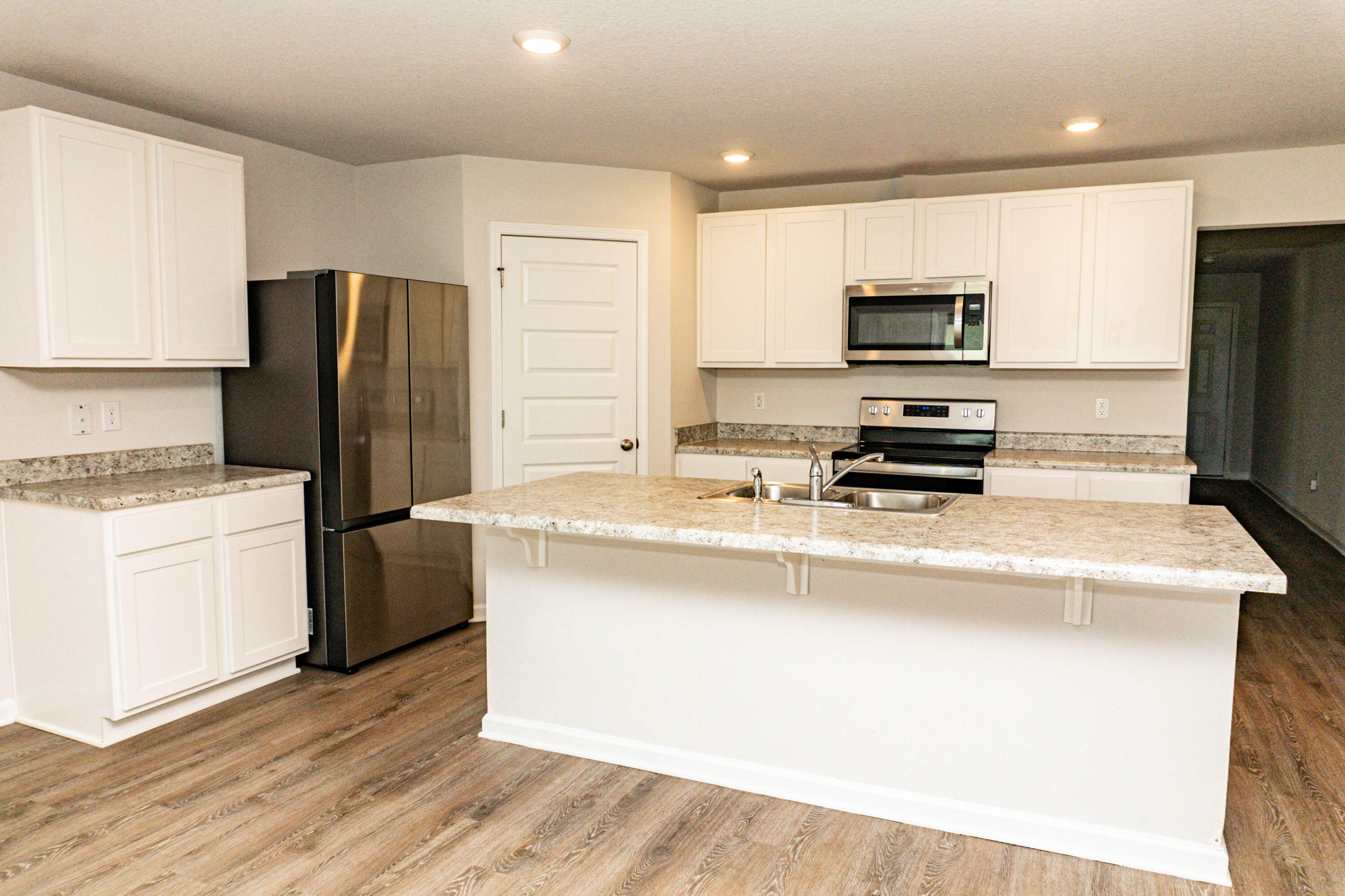 202 Laurel Hill Street Crestview, FL 32539 - Photo 4 of 25 a kitchen with stainless steel appliances a refrigerator stove and microwave