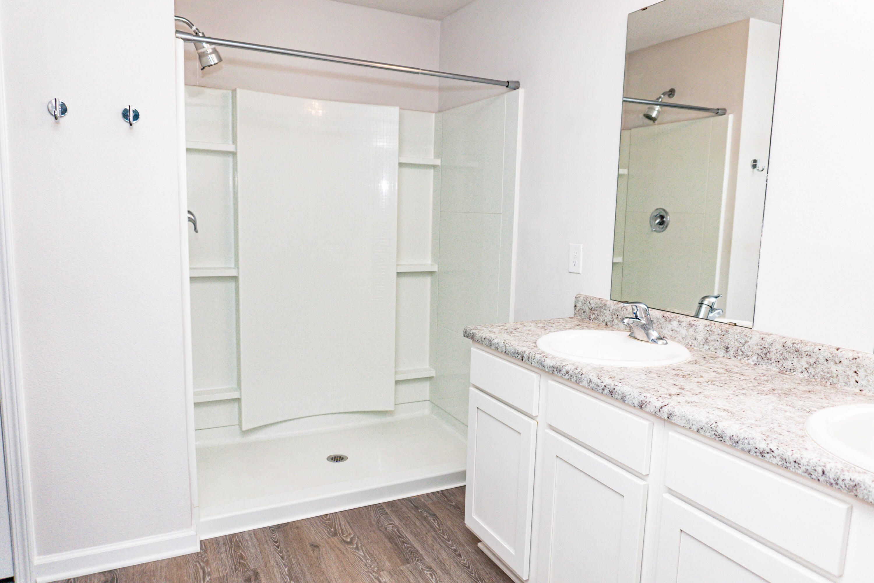 202 Laurel Hill Street Crestview, FL 32539 - Photo 8 of 25 a bathroom with a granite countertop sink a mirror a shower and a glass door