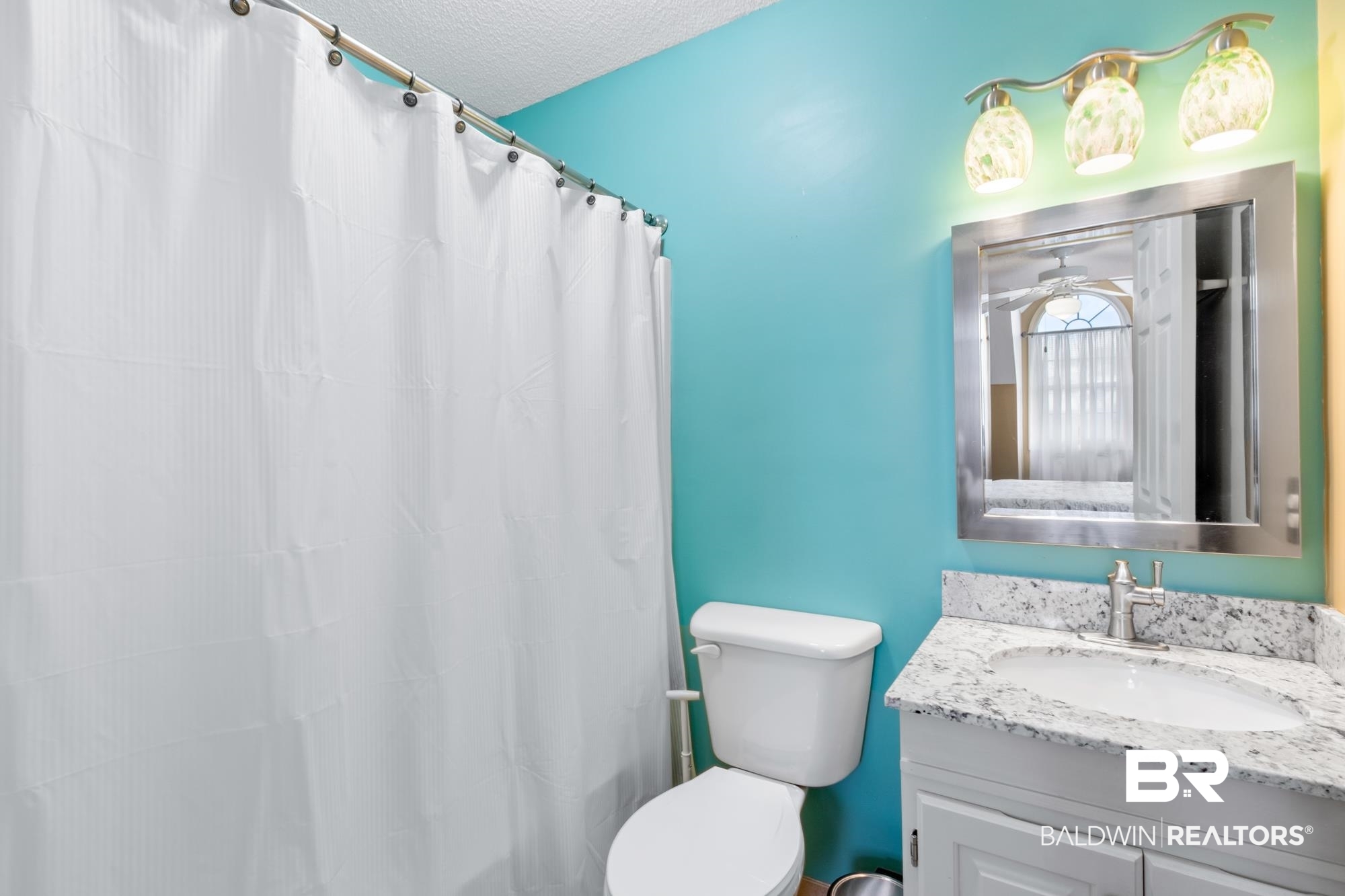 328 Windmill Ridge Road Gulf Shores, AL 36542 - Photo 26 of 47 Bathroom featuring ceiling fan, vanity, a textured ceiling, toilet, and a shower with shower curtain