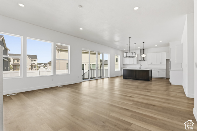 79 South Crimson Way West, Unit 307 Mapleton, UT 84664 - Photo 13 of 42 Spacious open-concept living area with light wood-finish flooring