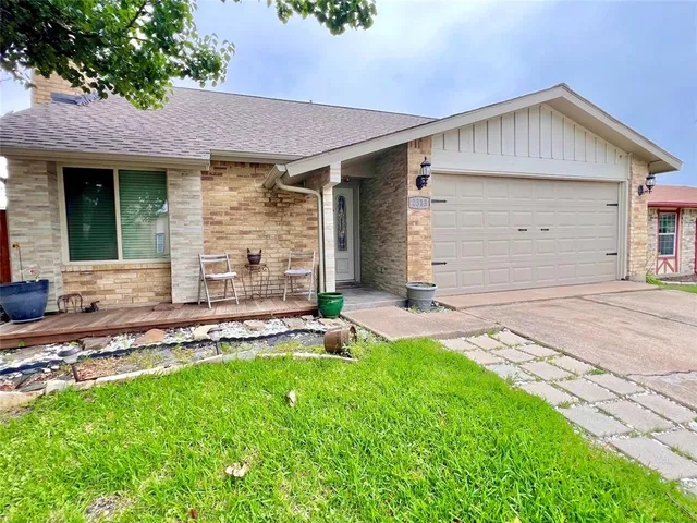 a front view of a house with a garden and yard