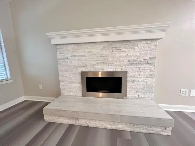 a living room with a fireplace and a rug