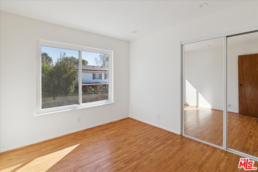 2216 Carlsbad Court Simi Valley, CA 93063 - Photo 22 of 32 a view of an empty room with wooden floor and a window