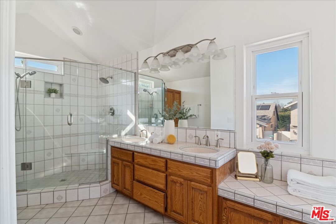 2216 Carlsbad Court Simi Valley, CA 93063 - Photo 29 of 32 a bathroom with a granite countertop sink mirror and shower