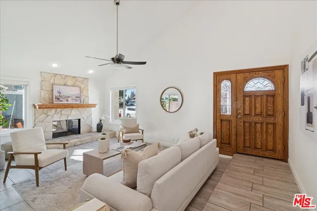 a living room with furniture a clock and a view of a livingroom