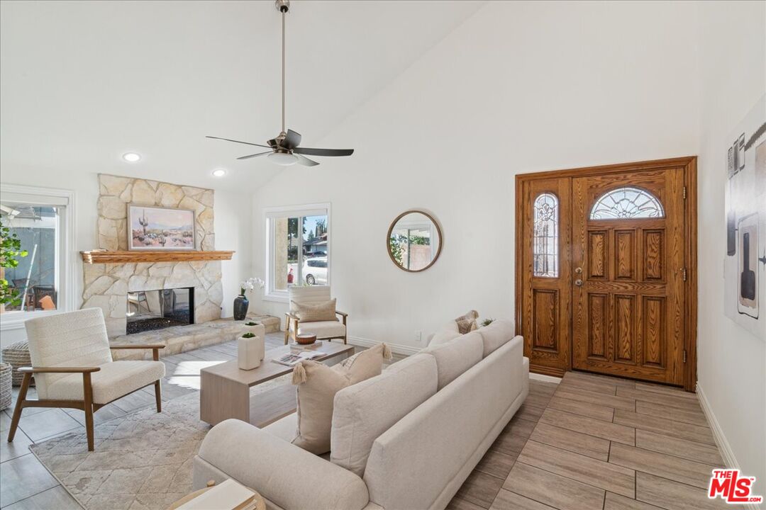 2216 Carlsbad Court Simi Valley, CA 93063 - Photo 3 of 32 a living room with furniture a clock and a view of a livingroom