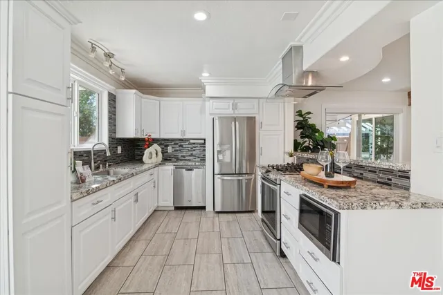 a kitchen with a stove top oven sink and refrigerator