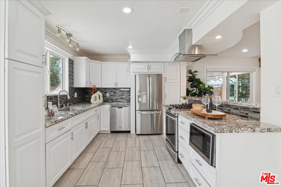 2216 Carlsbad Court Simi Valley, CA 93063 - Photo 7 of 32 a kitchen with a stove top oven sink and refrigerator