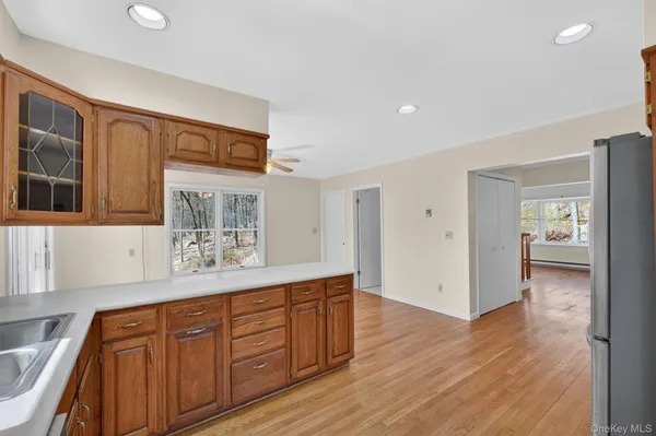 a hallway with cabinets and wooden floor