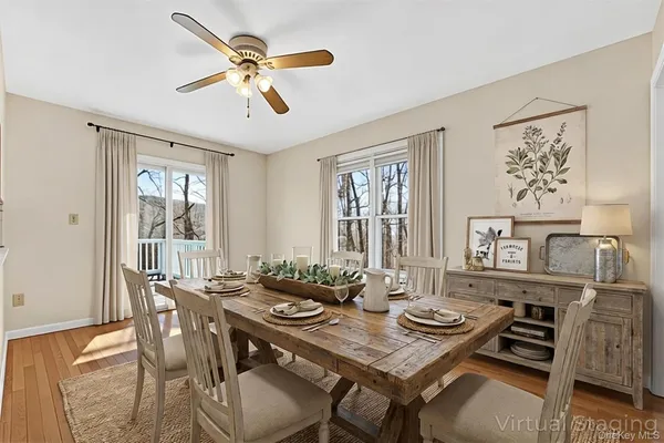 a view of a dining room with furniture window and wooden floor