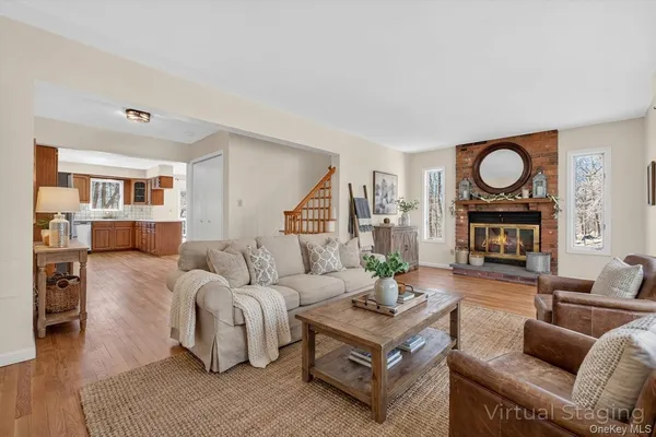 a living room with fireplace furniture and a wooden floor