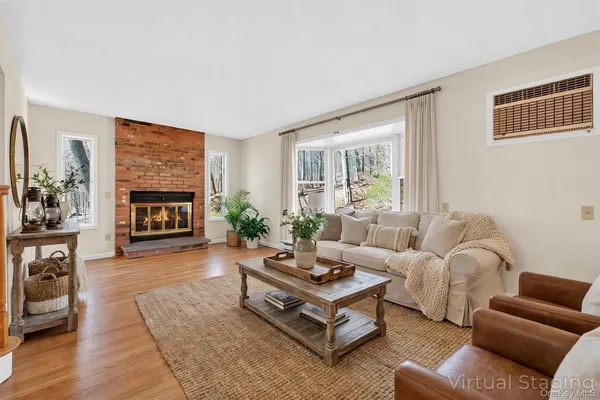a living room with furniture fireplace and window