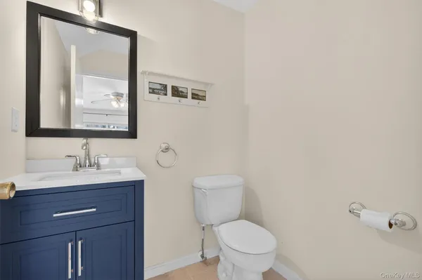 a bathroom with a toilet a sink and mirror