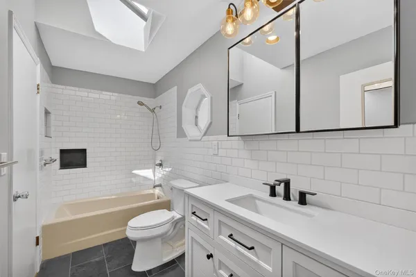 a bathroom with a sink a toilet and a bathtub
