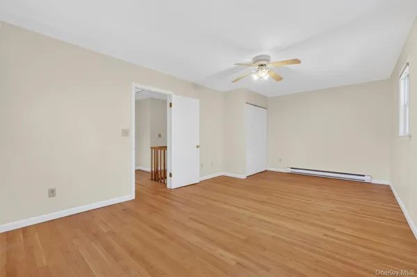 a view of empty room with ceiling fan