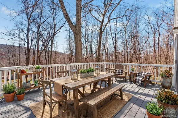 a view of a wooden chairs and table on the deck